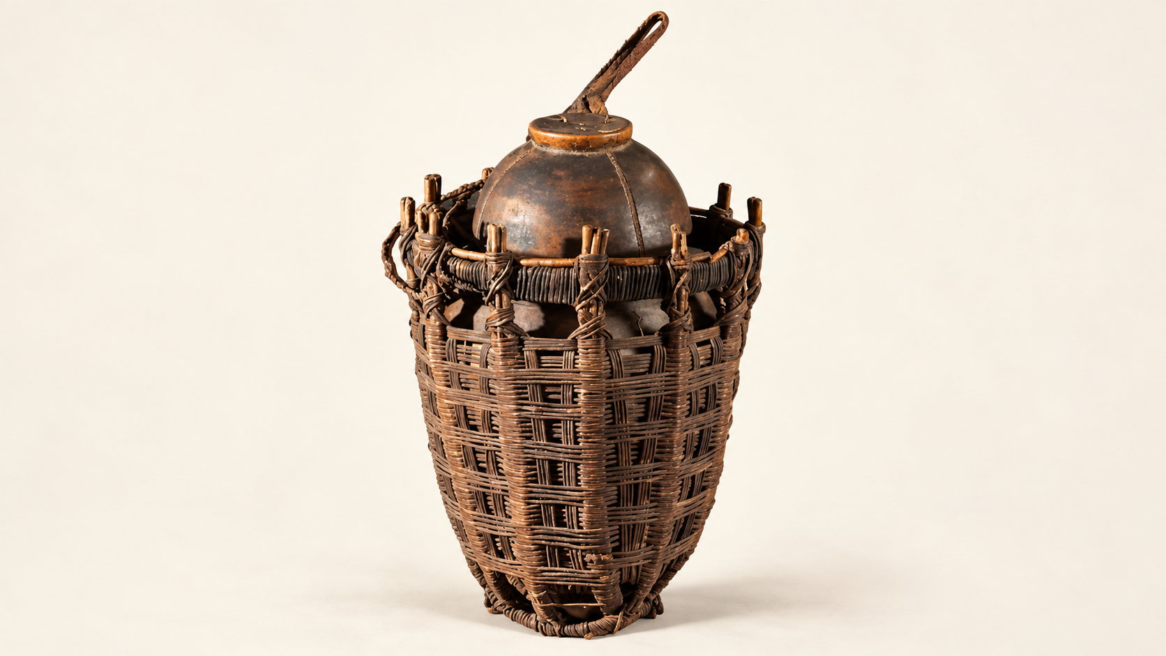 Traditional Somali milk vessel with a fitted lid and leather strap inside a protective woven basket